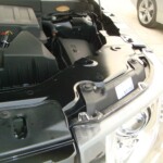 Before and after photographs of a damaged, black, Range Rover that was repaired by Elite Paint & Body Shop in West Palm Beach, FL.